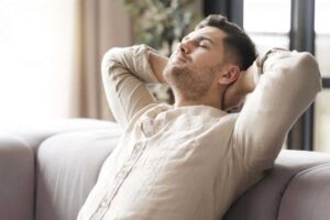 man relaxing on a sofa