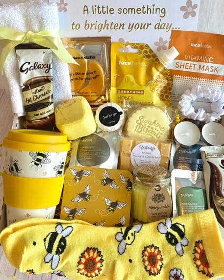 A selection of treats in a pamper hamper box all themed with the colour yellow