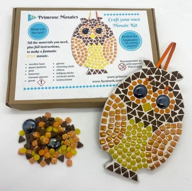Mosaic tiles, box and completed mosaic owl in a mosaic kit for adults
