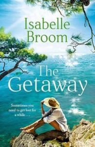 book cover for The Getaway by Isabelle Broom. A tanned woman wearing a sun hat and white coverall sits on rocks gazing out to a cerulean sky and sea