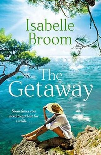book cover for The Getaway by Isabelle Broom. A tanned woman wearing a sun hat and white coverall sits on rocks gazing out to a cerulean sky and sea
