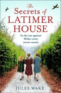 Book cover for The Secrets of Latimer House by Jules Wake. Three white women walking through an avenue of trees leading to a house