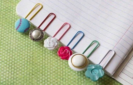 6 button bookmarks on a piece of paper made from buttons and paperclips