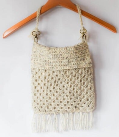 Granny square bag with a fringe and flap crocheted in oatmeal yarn