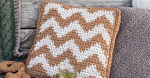 tapestry crochet pillow in a herringbone design in beige and cream yarn