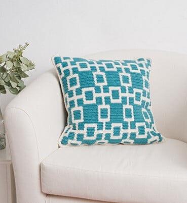 tapestry crochet pillow in a trellis pattern in turquoise and white