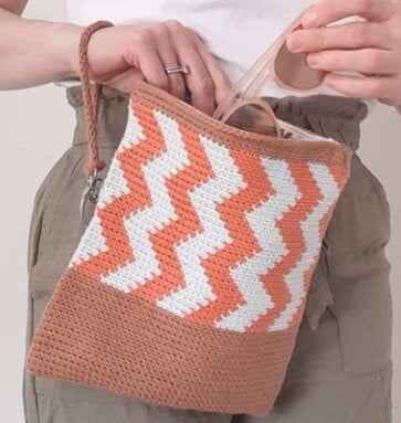 crocheted clutch bag in a tapestry pattern in white and brown