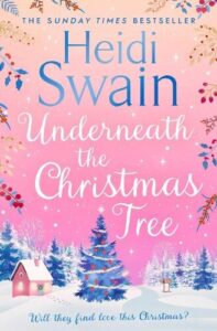 book cover for Underneath the Christmas Tree by Heidi Swain. Pink sky, snow on the ground, Christmas trees dotted around and a lodge