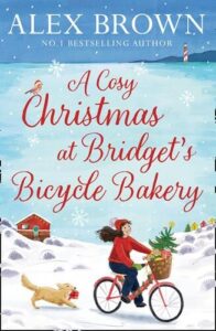 Book Cover for A Cosy Christmas at Bridget's Bicycle Bakery by Alex Brown. Vector image of a young woman with dark hair in a red jumper and jeans riding a bicycle across snow covered dunes with a dog running behind her