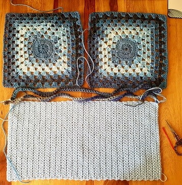 Two granny squares in tones of blue with a light blue crocheted inner lining