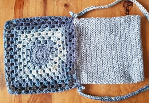 granny square bag in self striping blue yarn with the inner lining pulled out