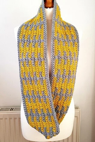 crochet infinity scarf using mosaic technique in yellow and grey looped round the neck once