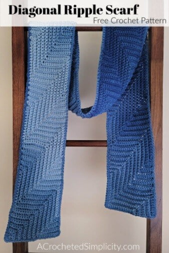 blue crocheted scarf hanging on a ladder