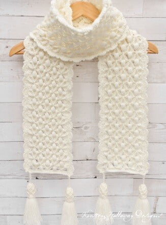 crocheted scarf in white on a coat hanger