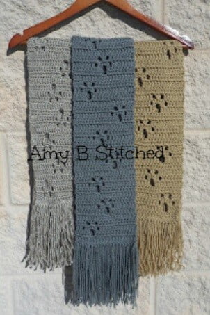 3 crocheted scarves in grey, blue and beige with paw prints made with picot stitches