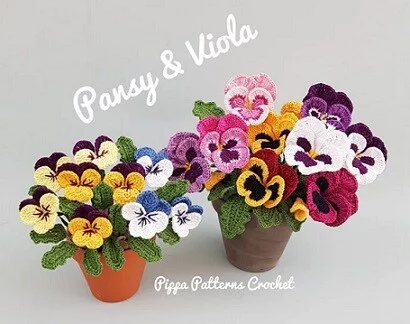 crochet pansy and viola in a terracotta pot and green pot
