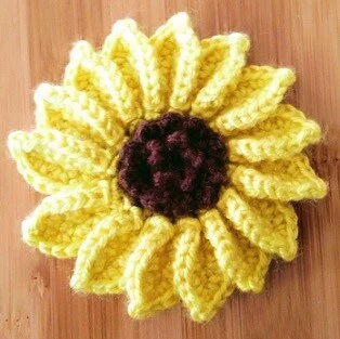 crochet sunflower head on a wooden background