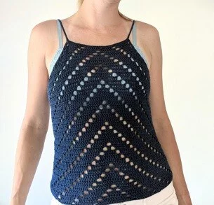woman from the shoulders down wearing a blue crochet tank top