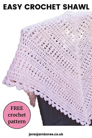 lacy crochet shawl in pink draped over the back of a chair