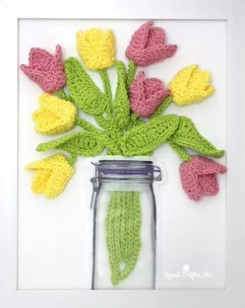 pink and yellow tulips crocheted and mounted on a canvas and frame