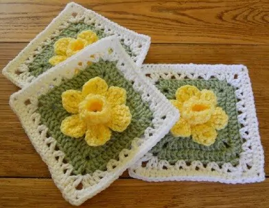 3 granny squares with a raised daffodil in the centre