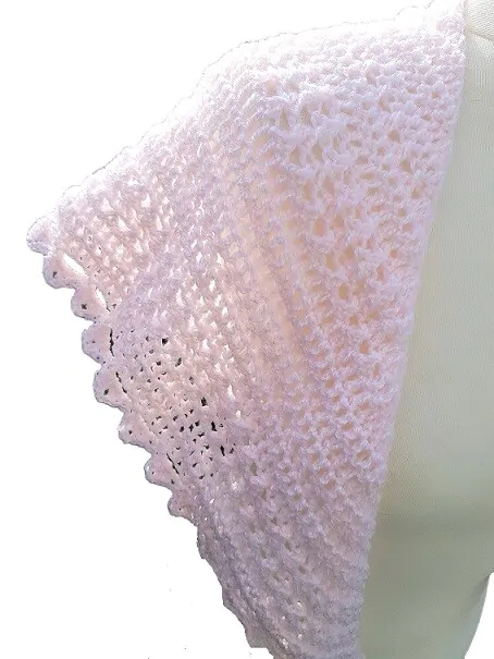 crochet shawl showing the left side of the lacy pattern