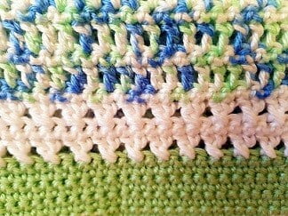 treble crochet, double crochet and crossed treble stitches in green, green and blue, white