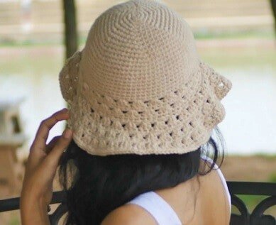 The back view of a woman wearing a hat