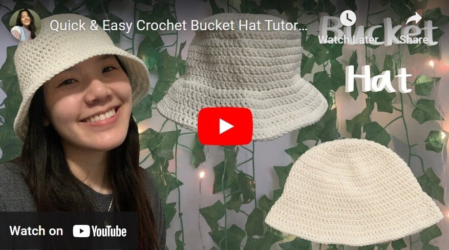 A woman is wearing a cream crochet bucket hat