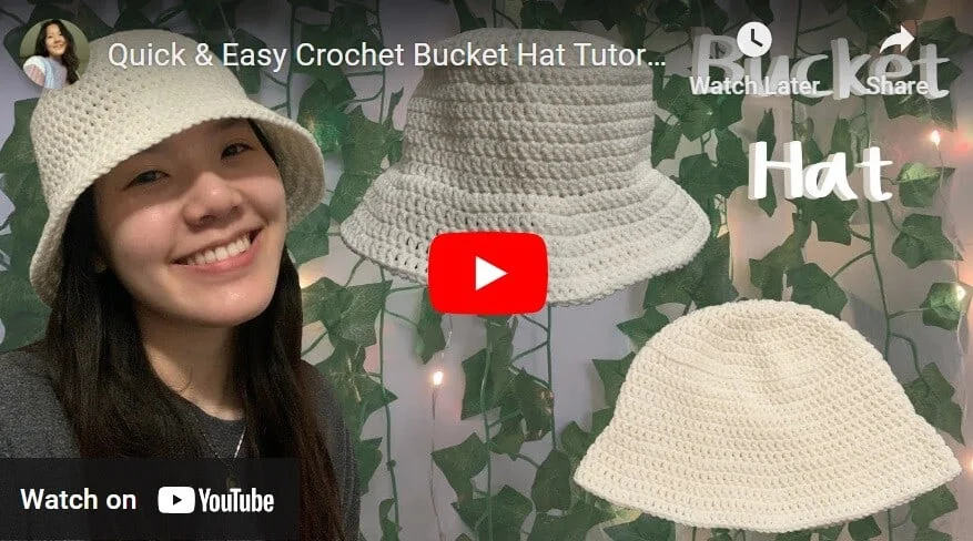 A woman is wearing a cream crochet bucket hat