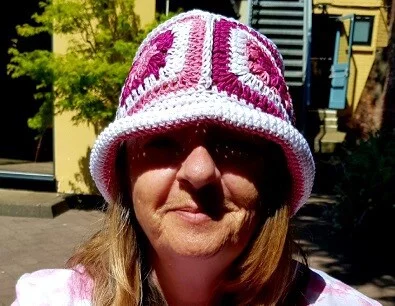 bucket hat crocheted in cotton being worn on a sunny day to shade the woman's face