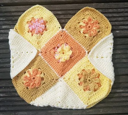 Granny squares joined together and folded to form the body of a tote bag