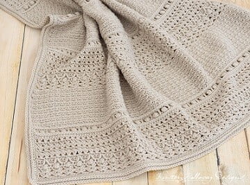 crochet baby blanket in a neutral colour