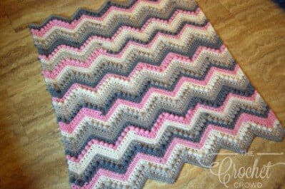 chevron stripe and bobble stitch blanket in pink and shades of grey