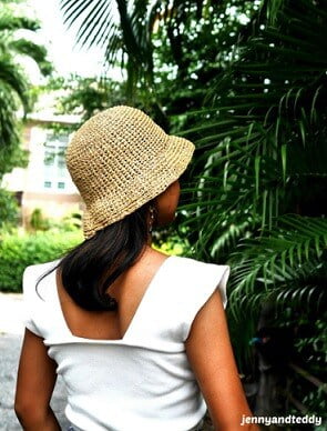 women wearing a raffia crochet hat