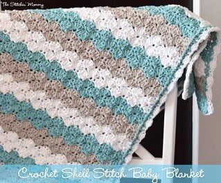 blanket crocheted in shell stitch in light blue, beige and white