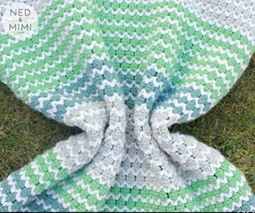 Blanket crocheted in spring greens and blues