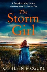 book cover for The Storm Girl by Kathleen McGurl. A woman wearing a lapiz coloured full length cloak stands facing away from the cover towards a stormy sky