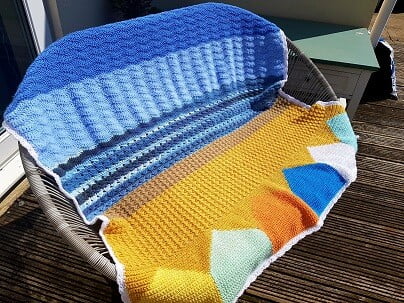 crochet blanket draped over garden furniture