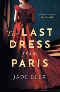 book cover for The Last Dress from Paris by Jade Beer. A woman is facing away from the cover and she is dressed in a sumptuous silk dress