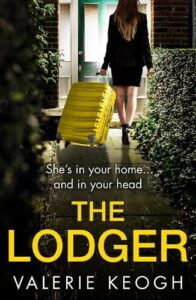 book cover for The Lodger by Valerie Keogh. A woman in a black suit is wheeling a yellow suitcase towards a front door