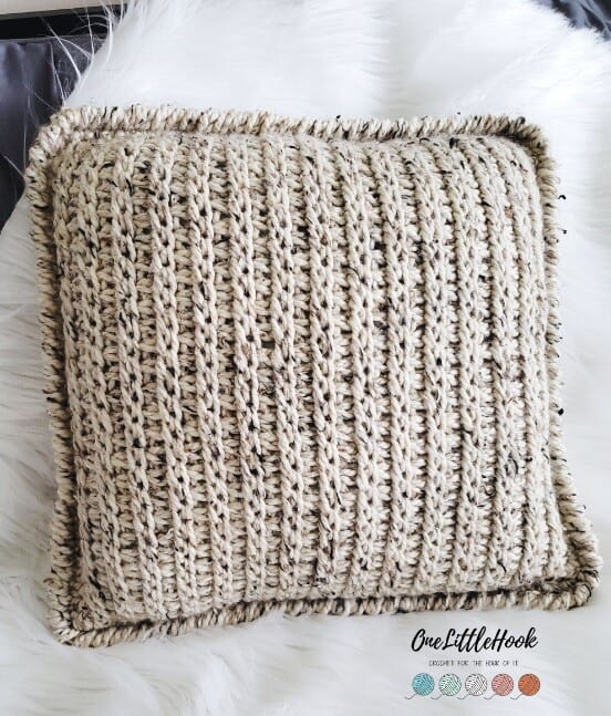 a cushion cover and insert showing the Tunisian crochet stitch