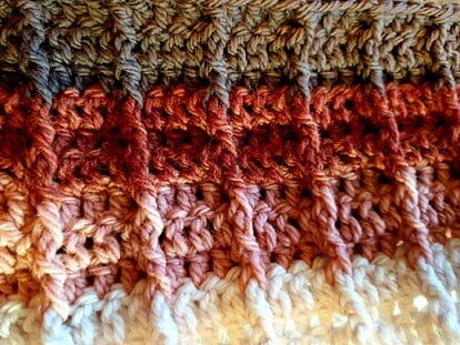 close up of front post and back post treble crochet stitches in an infinity scarf