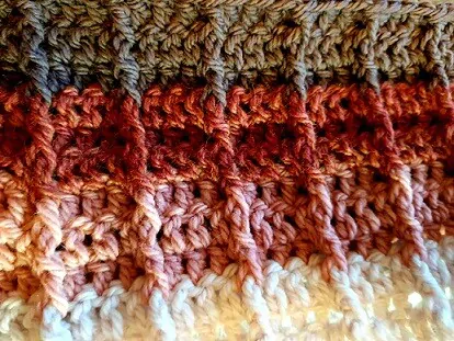 close up of front post and back post treble crochet stitches in an infinity scarf
