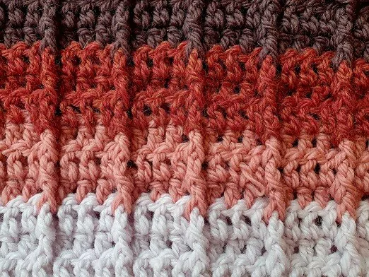 The right side of crocheted fabric in an infinity scarf pattern