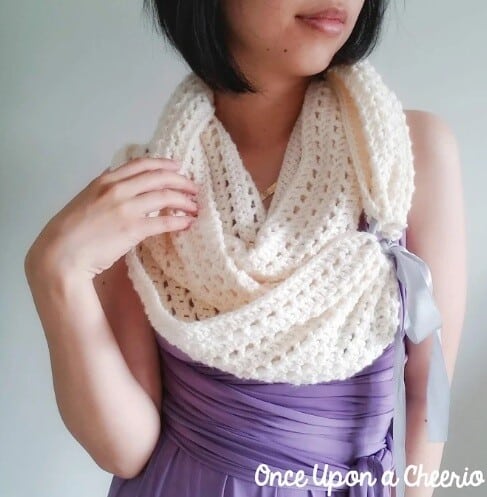 woman wearing an infinity scarf joined with a ribbon to match bridesmaid dress