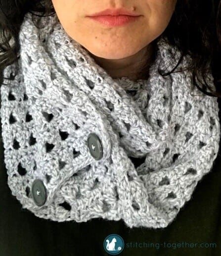 Open work lightweight infinity scarf with the ends joined by buttons