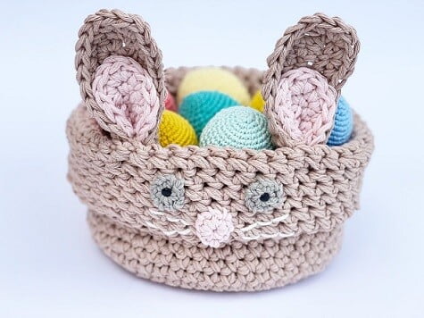 Basket with two sets of bunny ears and a bunny face embroidered on one side