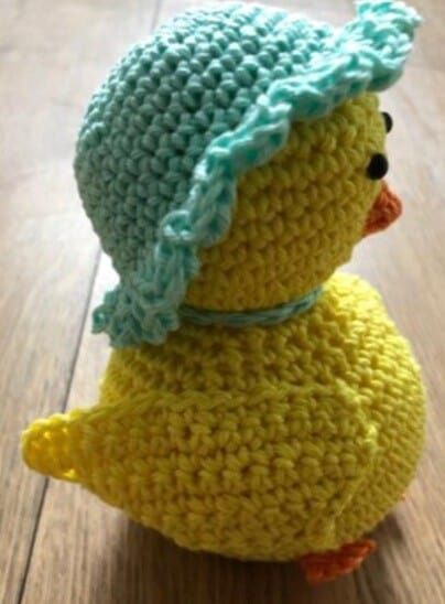 Easter chick wearing a blue bonnet