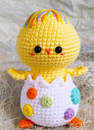 Crocheted chick coming out of a spotted egg